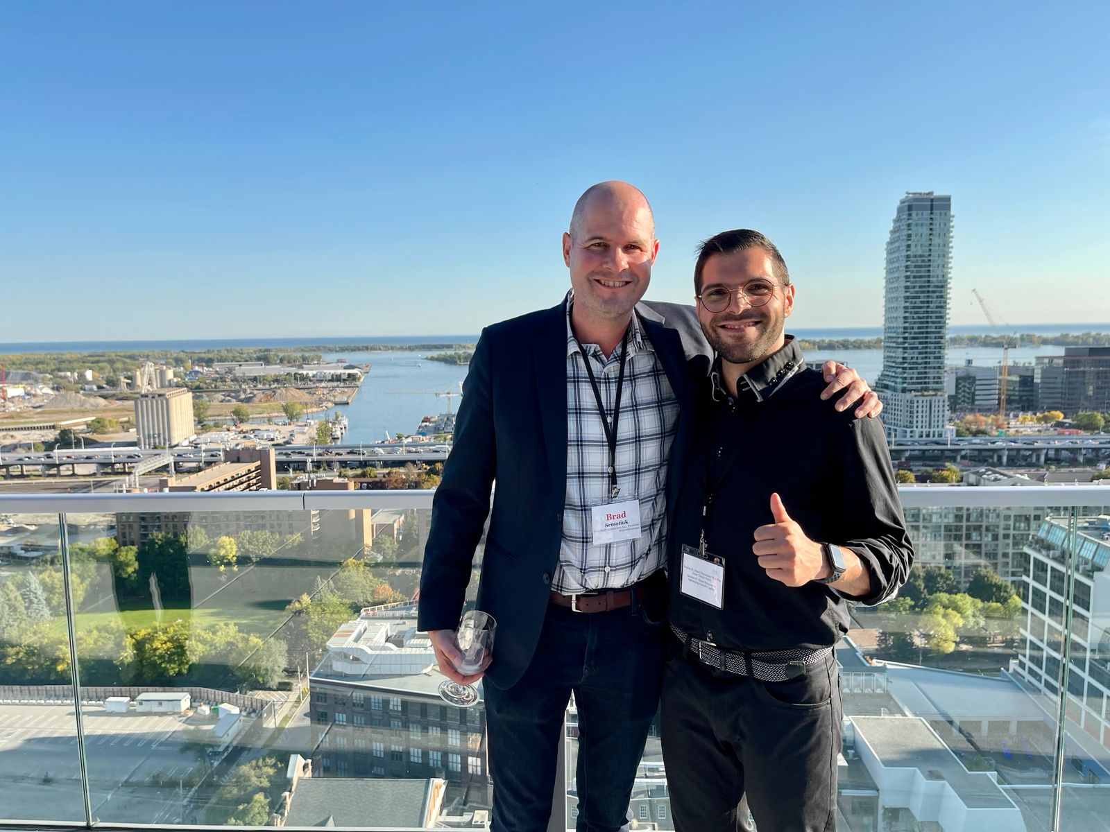 Brad Semotiuk and Elvine Assouline on a rooftop overlooking the Toronto waterfront