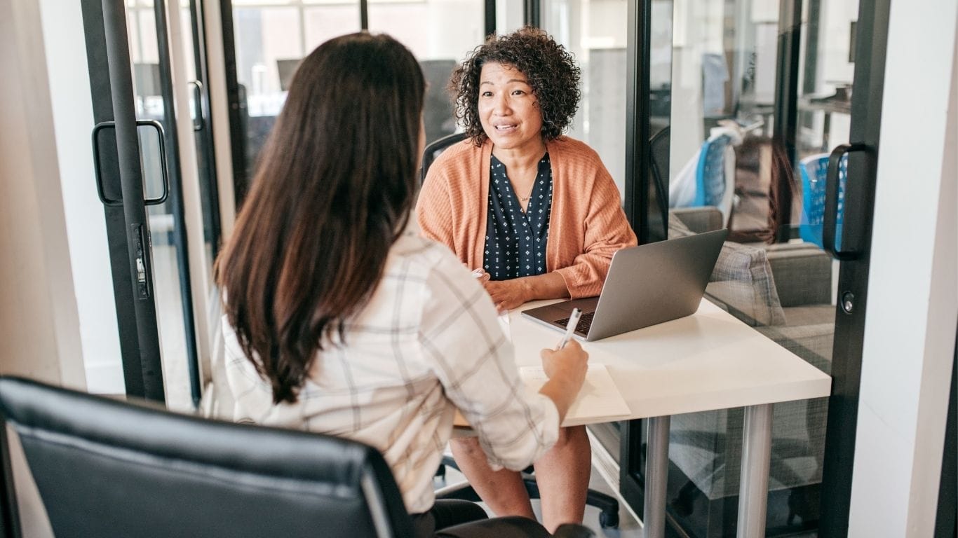 A founder interviewing a candidate across a table in a small Canadian office